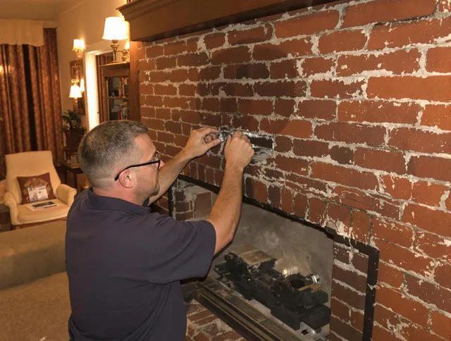 Lewisboro Chimney Sweep expert fixing a fireplace in Lewisboro, NY